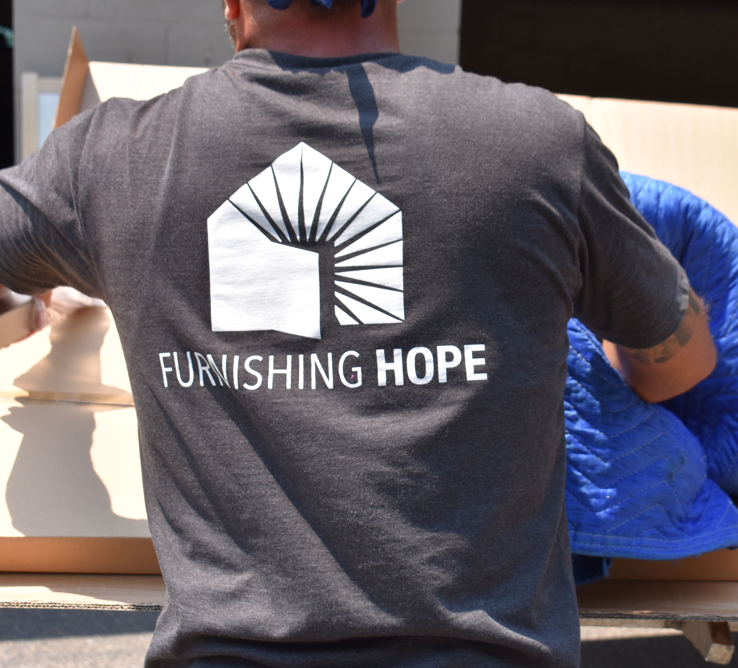 Furnishing Hope volunteer moving furniture