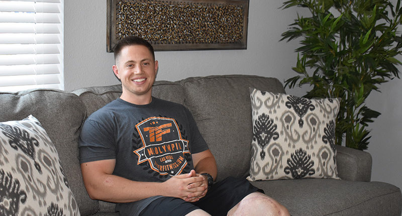 LCpl Bryan White sitting on his newly furnished sofa